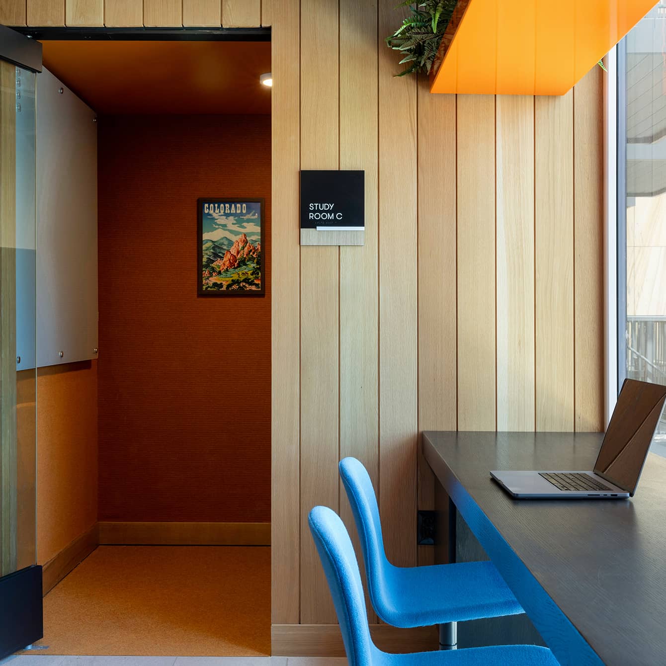A desk with a laptop on it