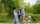 Friends greeting each other near a bicycle