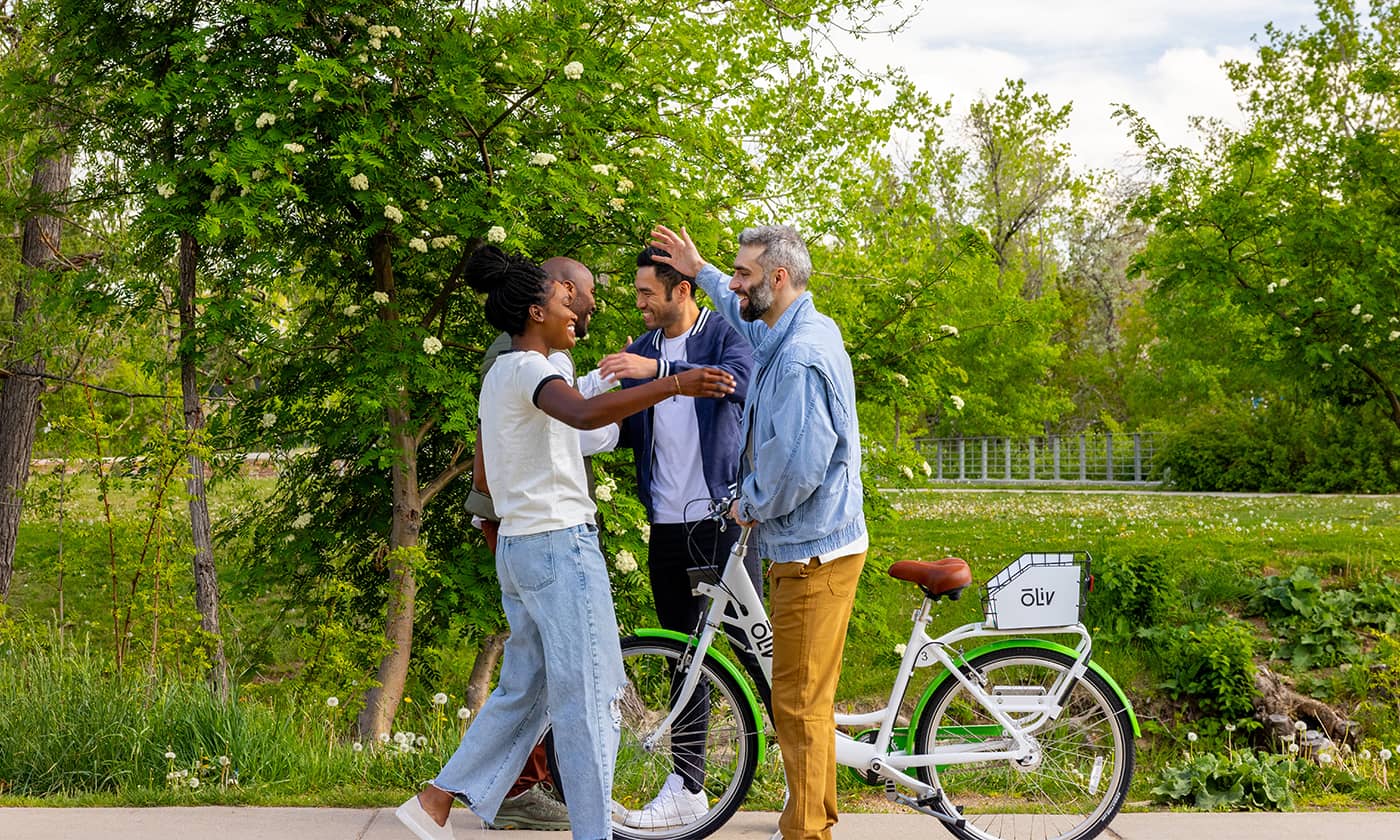Friends greeting each other near a bicycle