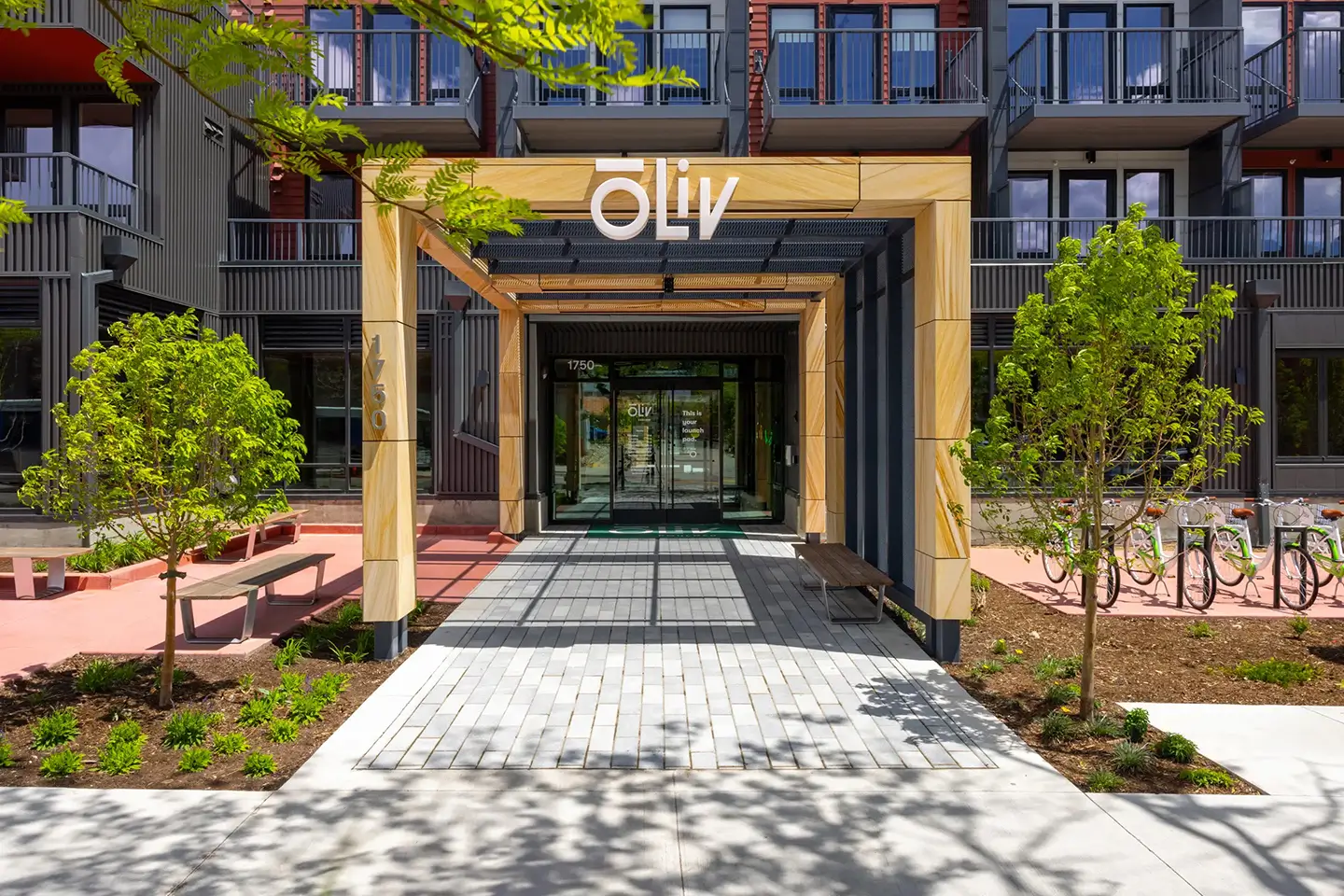 Entrance to oLive Boulder with nice landscaping, benches, and bike racks.